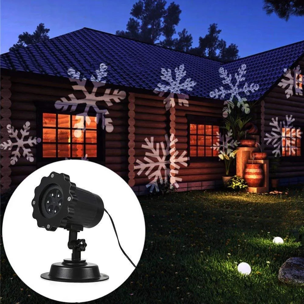 LED Christmas snowflake laser light projector IP65 waterproof with white snowflakes projecting onto a garden wall at night