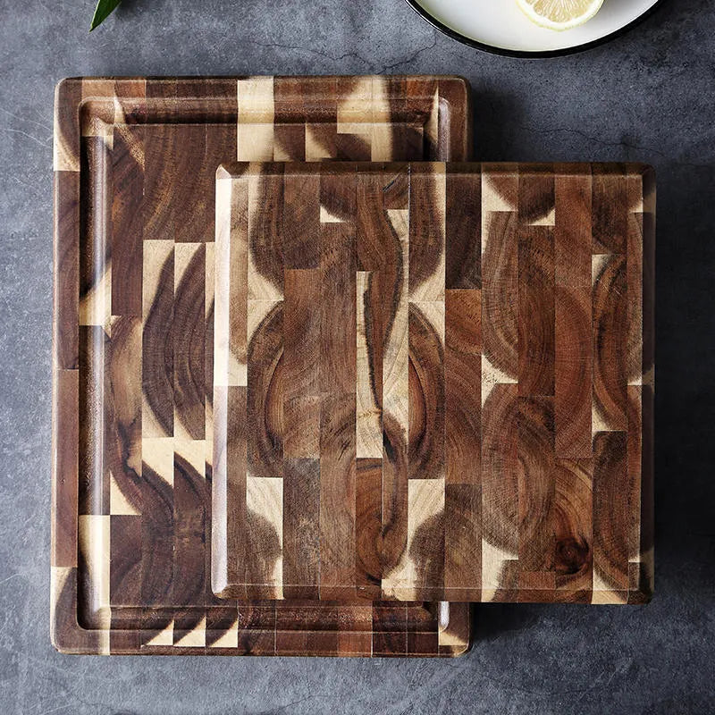 Brown parquet pattern solid acacia wood chopping board on a kitchen counter.