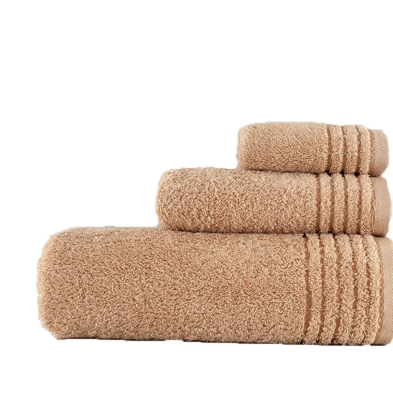 Beige and brown cotton towel set showing three sizes: square face cloth, hand towel, and bath towel.