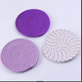 Three round cotton cord coasters in different colours showing 18cm diameter size