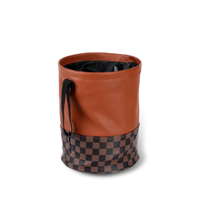 Brown retractable leather trash can for car interior use, shown with handle.