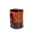 Brown retractable leather trash can for car interior use, shown with handle.