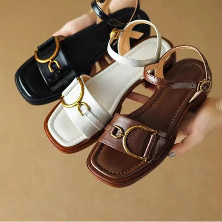 Women's black leather thick-soled sandals with a round toe and buckle closure on a white background