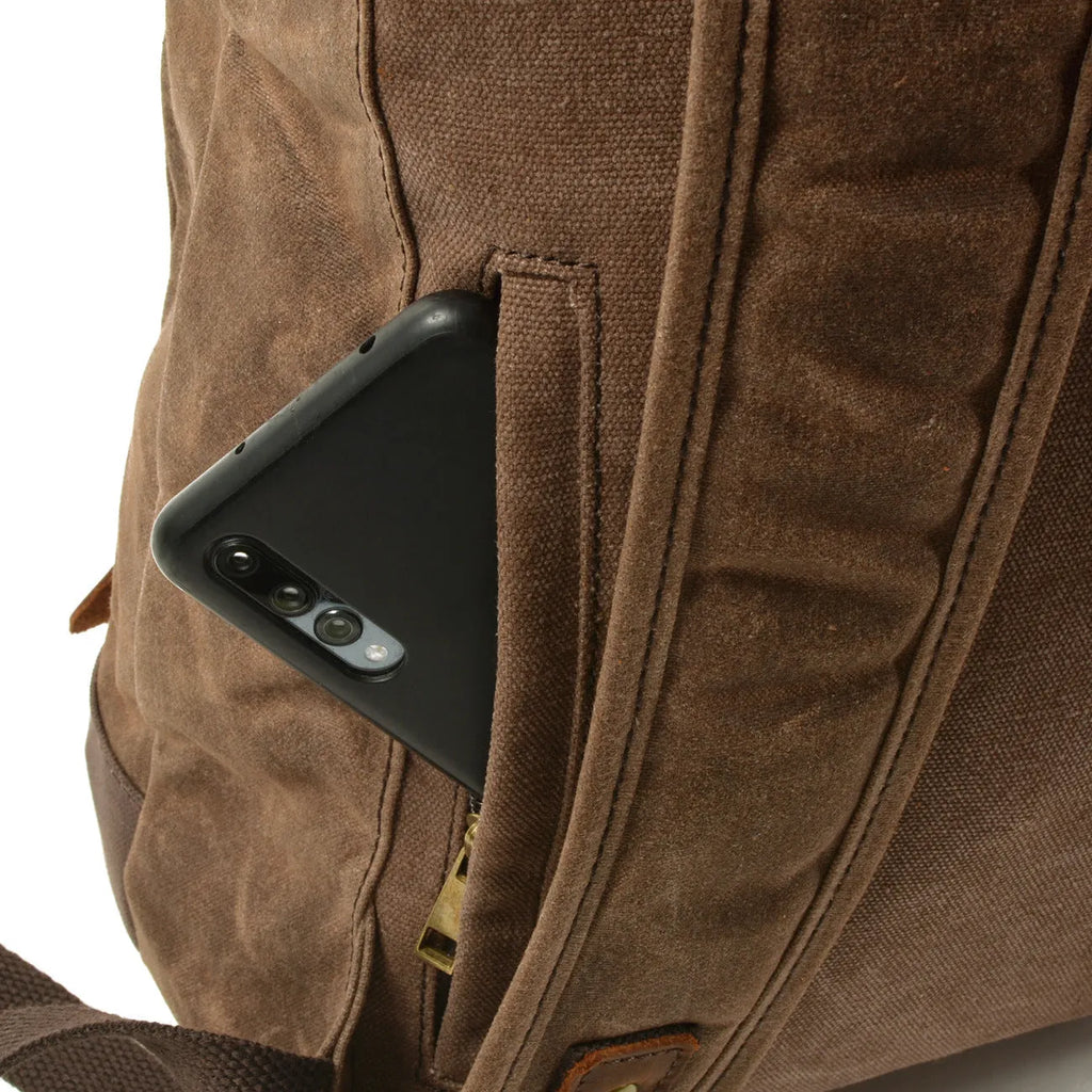 Waterproof canvas rucksack with linen lining, 20-35L capacity, softback design, shown in black, coffee, or celadon colour options.