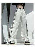 Women's loose straight-leg trousers with contrast ribbon parallel bars detail in navy blue