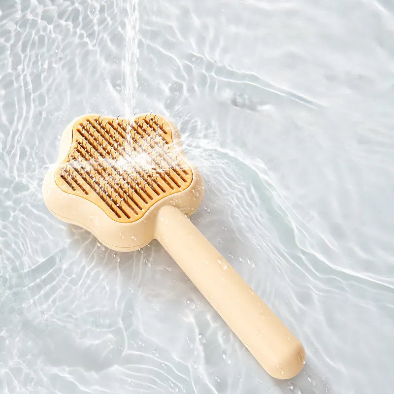 Magic wand cat comb with stainless steel needle teeth and self-cleaning mechanism in green colour
