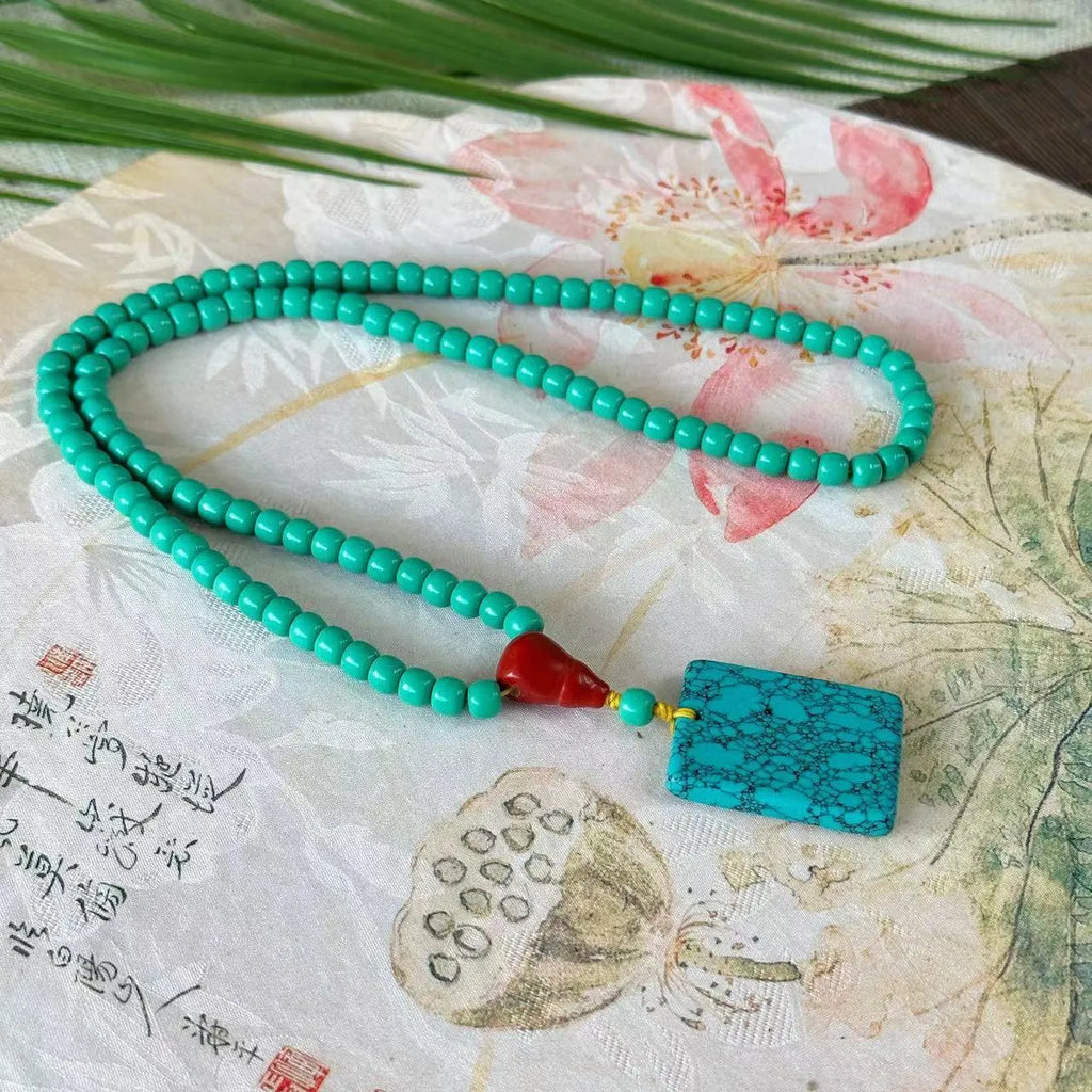 Turquoise mesh flower lucky pendant necklace with adjustable ball bead chain, hand-woven design detail shown