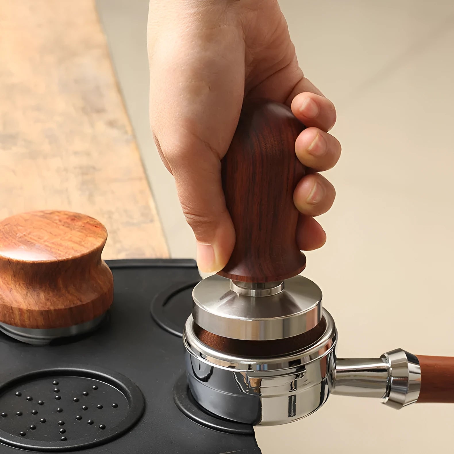 Black silicone coffee powder press pad with stainless steel base and aluminium handle