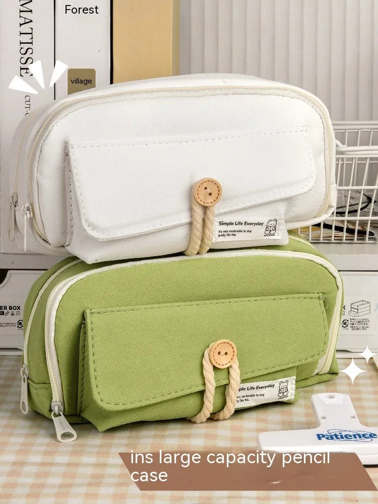 Canvas pencil case in green, beige, blue, or grey storing about 80 pens