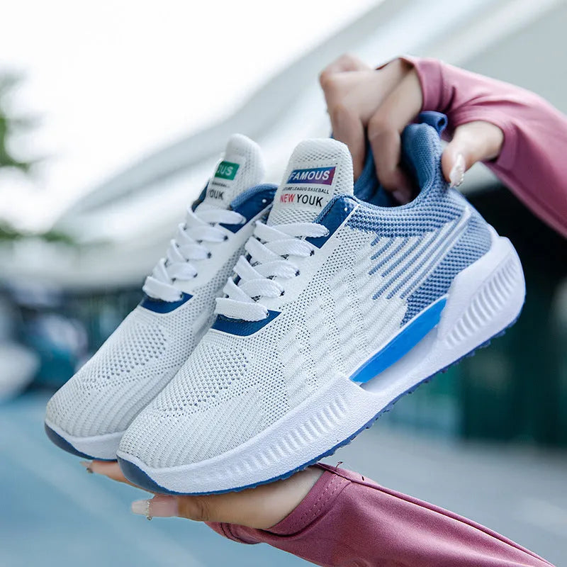 Men's blue casual sports mesh shoes with round toe and cloth upper on a plain background.