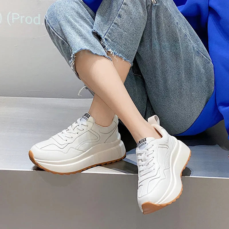 Women's beige cowhide leather casual sports shoes with round toe and cross-strap detail.