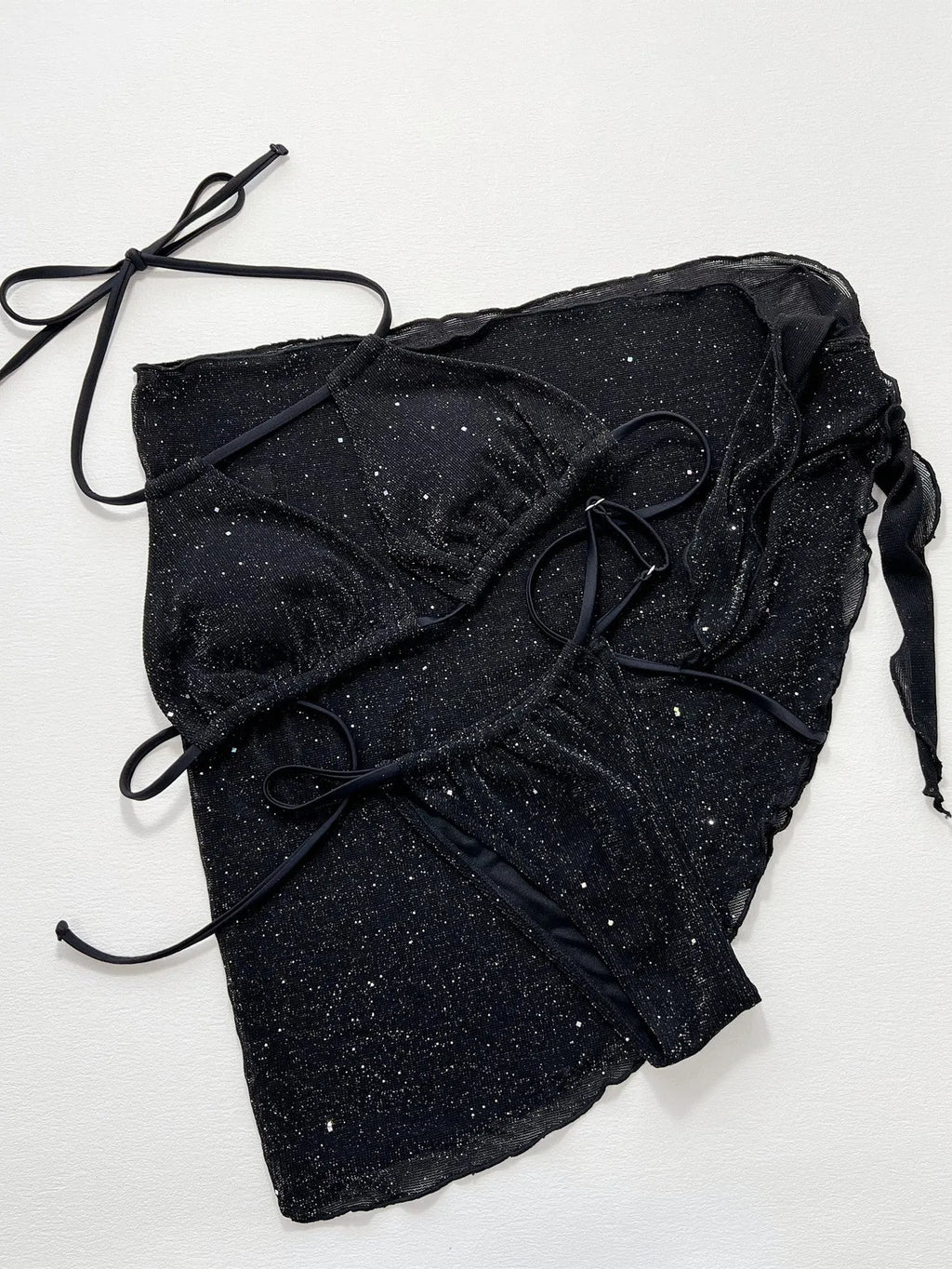 Black three-piece bikini swimsuit set with a top and shorts on a mannequin.