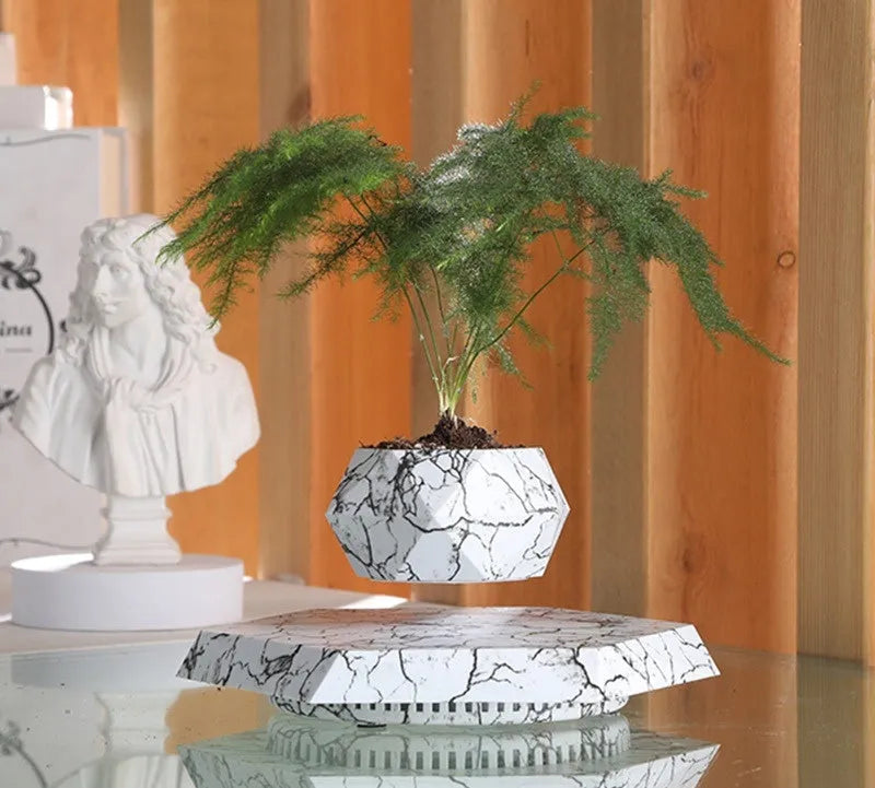 Marbled colour levitating plant pot floating above base with magnetic technology
