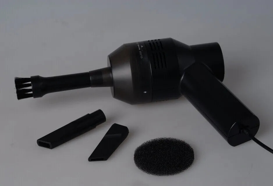 Black cordless USB desktop mini vacuum cleaner for keyboard and computer dust clean-up.