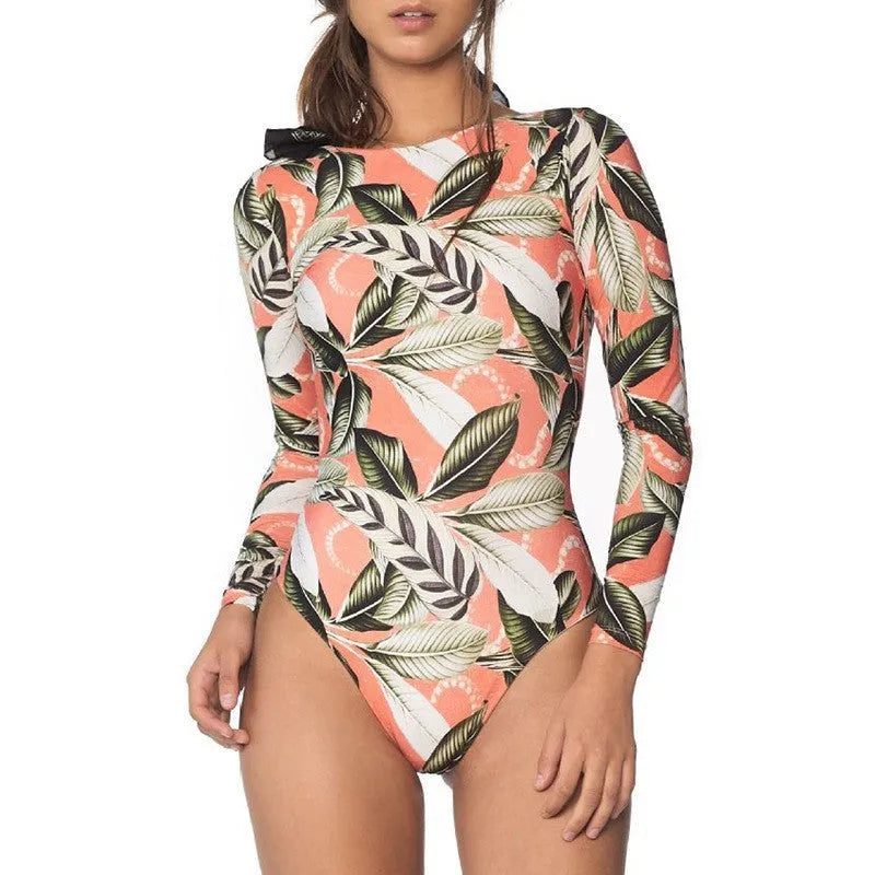 Women's leaf printed backless one-piece swimsuit on a model, showing floral pattern and conservative cut.