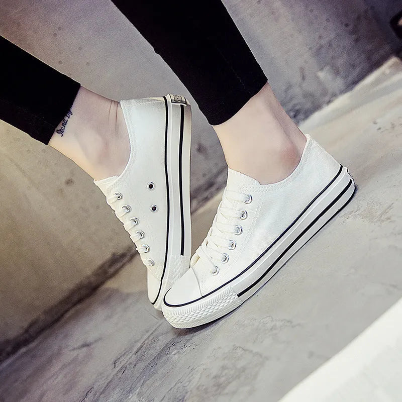 Women's casual lace-up canvas shoes in solid colours on a white background.
