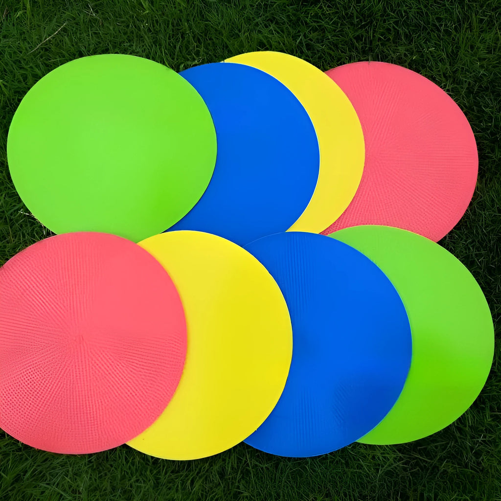 Yellow football training target disc with 23cm diameter on grass pitch