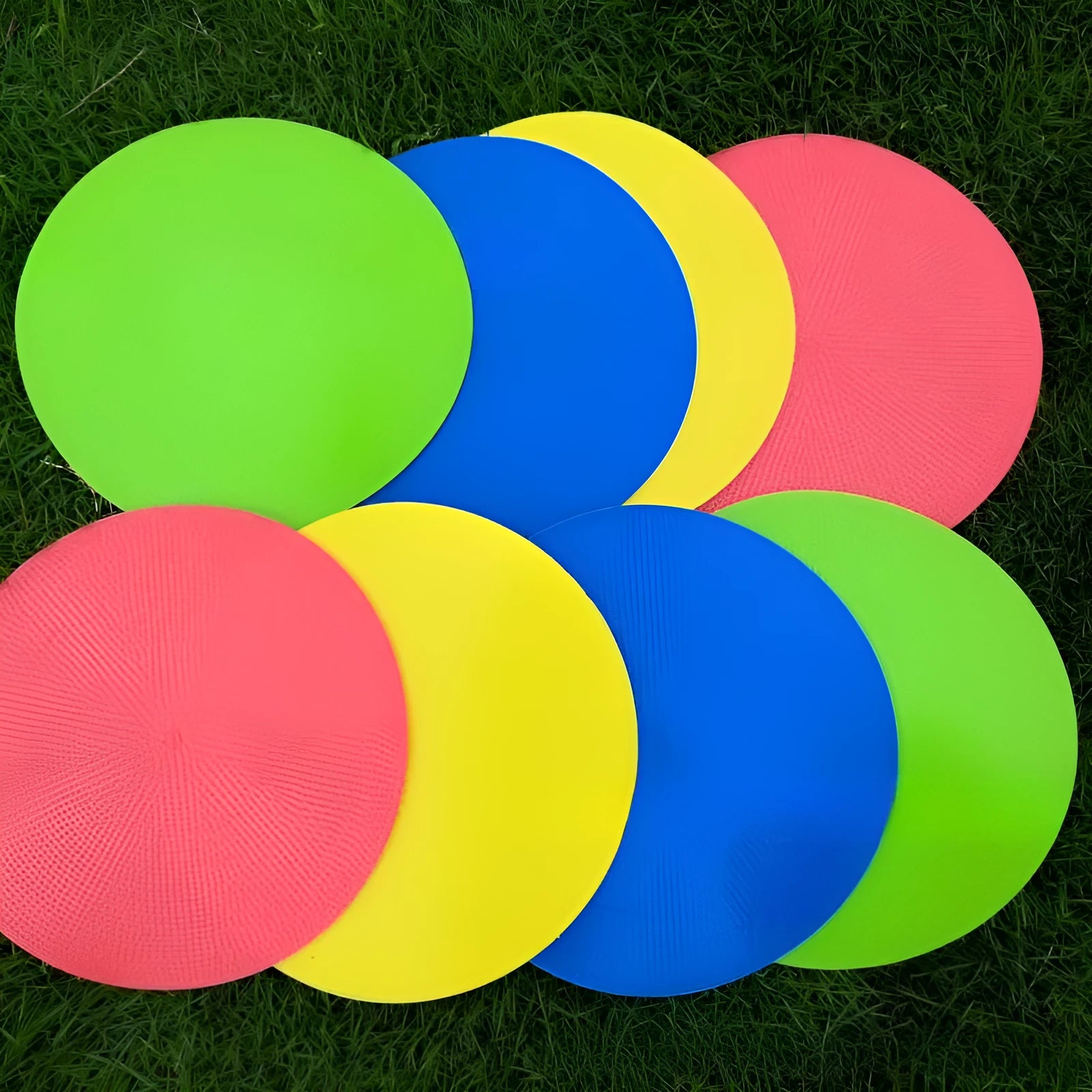 Yellow football training target disc with 23cm diameter on grass pitch