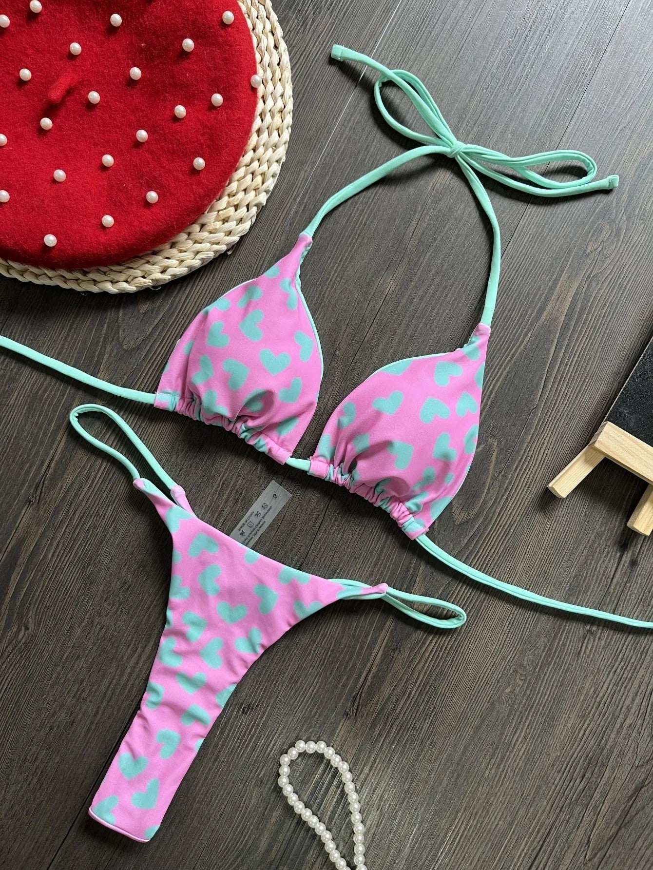 Women's red heart print backless one-piece swimsuit with a side split.