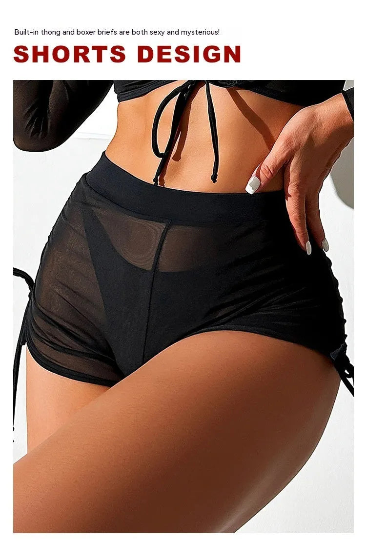 Black long sleeve mesh bikini four-piece swimsuit set for women on a mannequin.