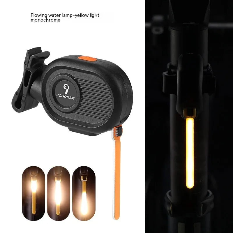Blue bicycle taillight showing a running water drops light pattern, mounted on a bike seat post.