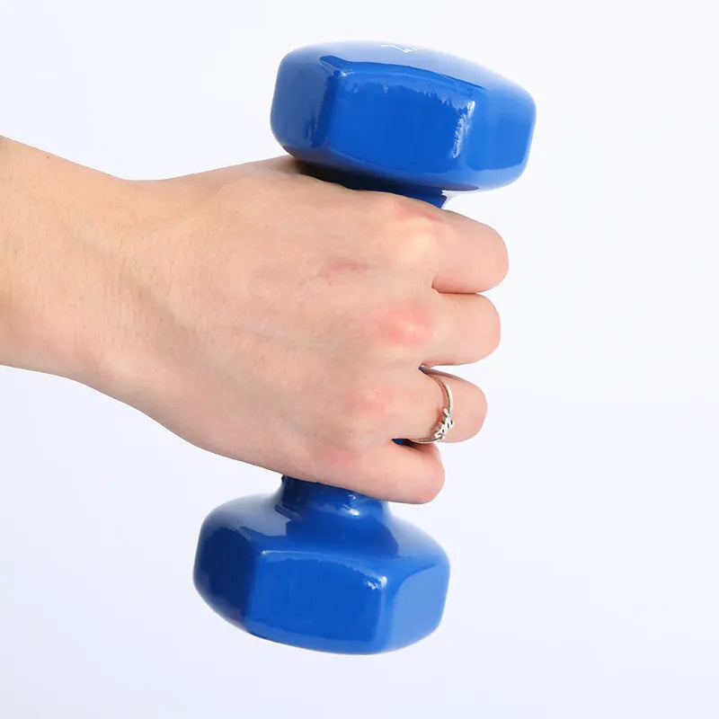 Bright plastic coated fitness dumbbells in various weights for home gym yoga and aerobics