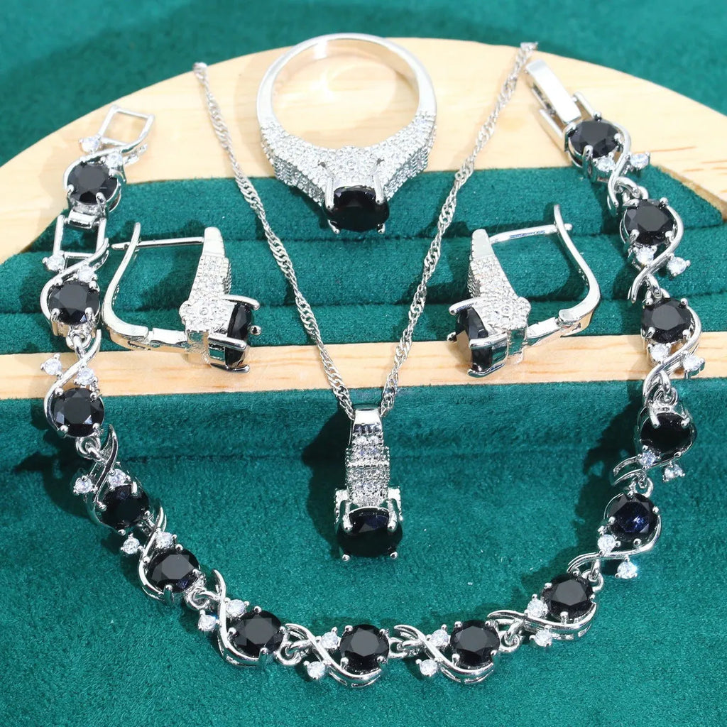 Four-piece bridal jewellery set showing zircon necklace, bracelet, earrings, and ring in coordinating design