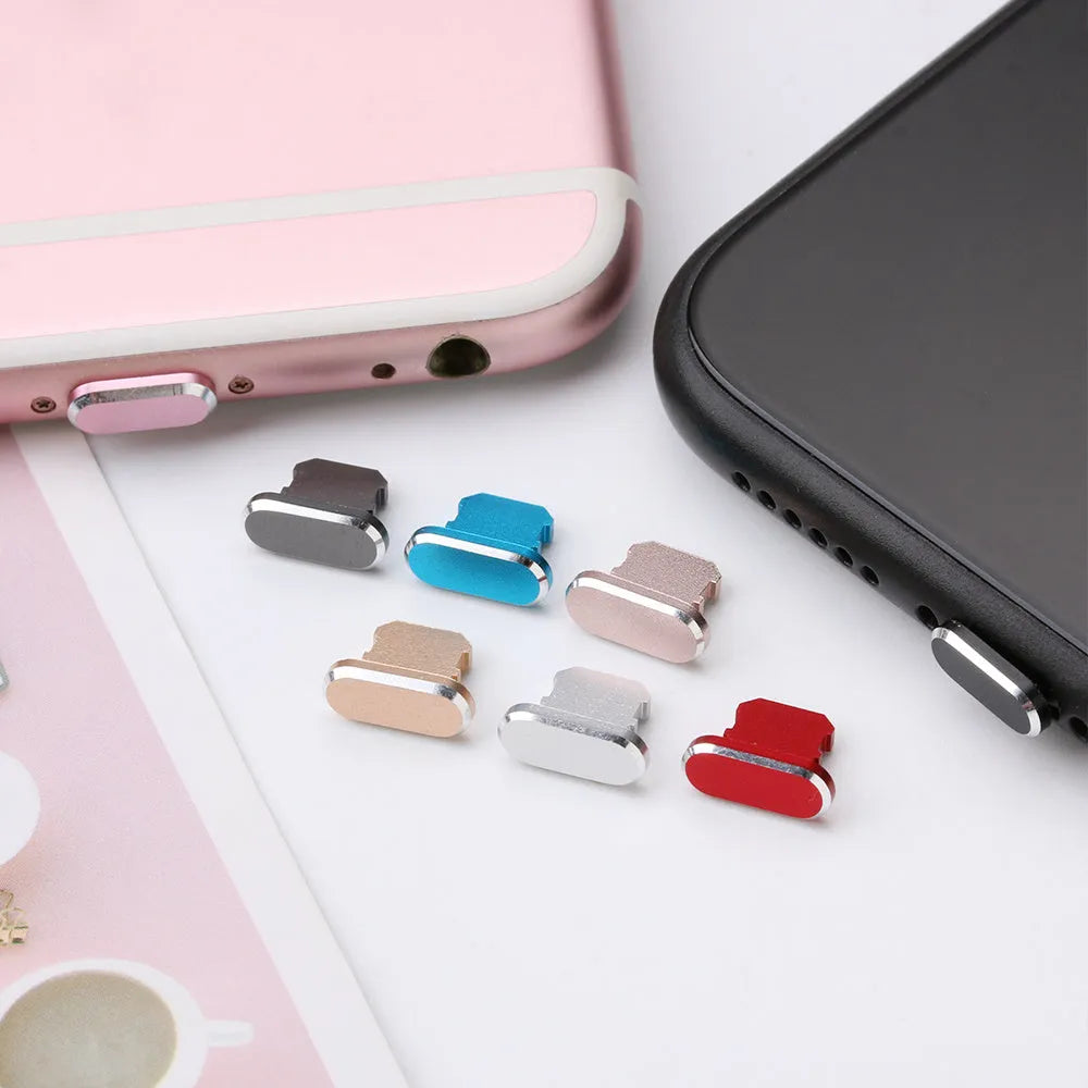 Aluminium alloy iPhone charging port dust plug in various colours including gold, silver, blue, and rose gold.