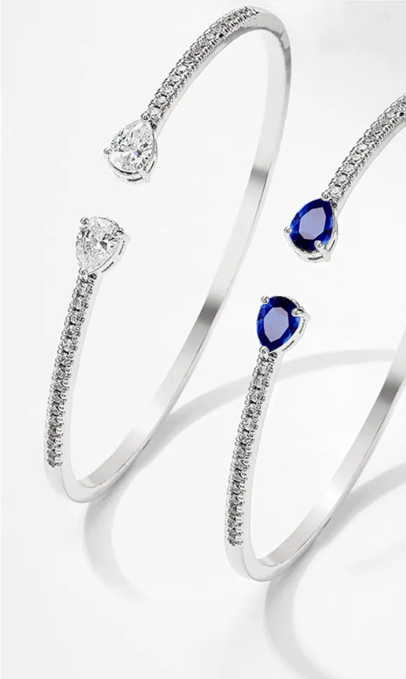 Copper bracelet with inlaid zircon decoration in blue colour on wrist