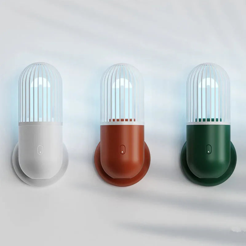 Portable capsule-shaped UVC disinfection lamp in black, showing compact size.