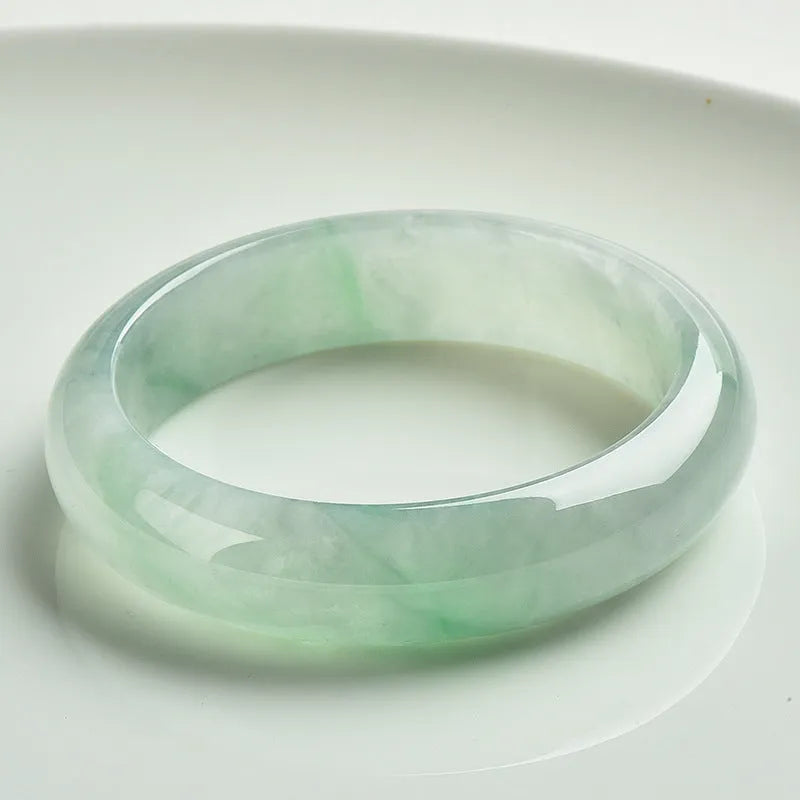 Light green jade bead bracelet showing natural stone texture with sizing options from 53mm to 64mm
