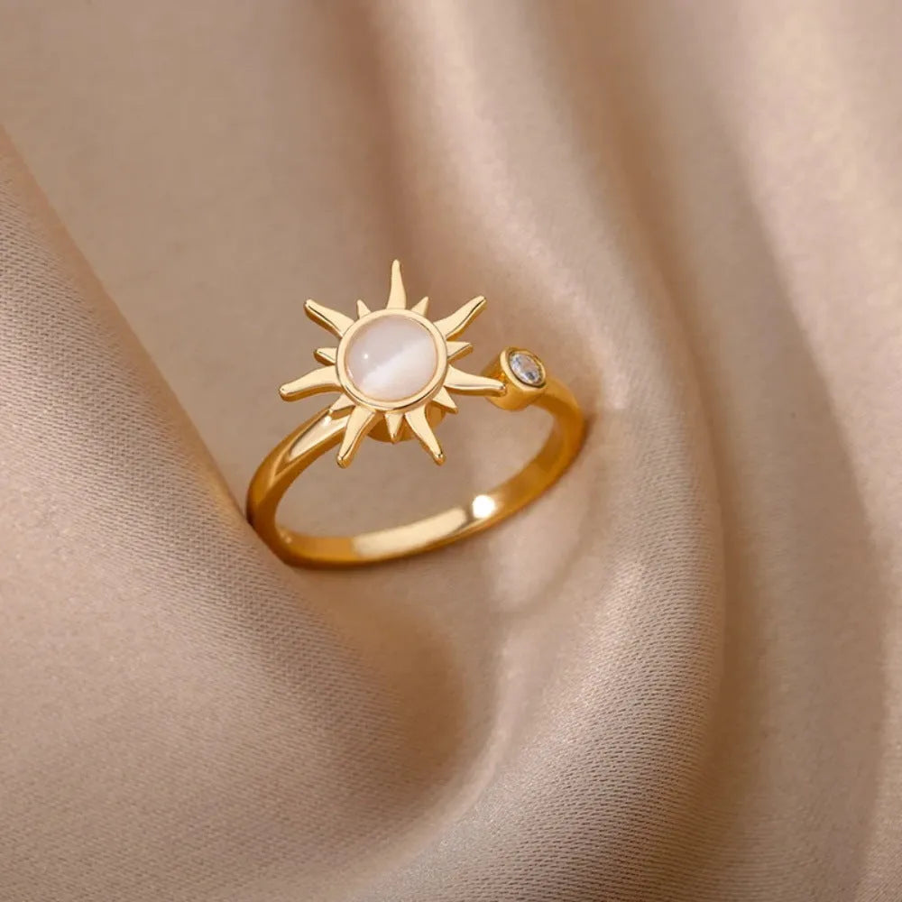 Gold and platinum adjustable geometric decompression spinner rings showing rotatable design