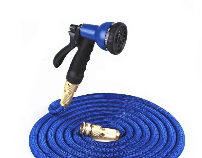 Expandable magic flexible water hose in black laid on grass showing compact initial length and stretched working length