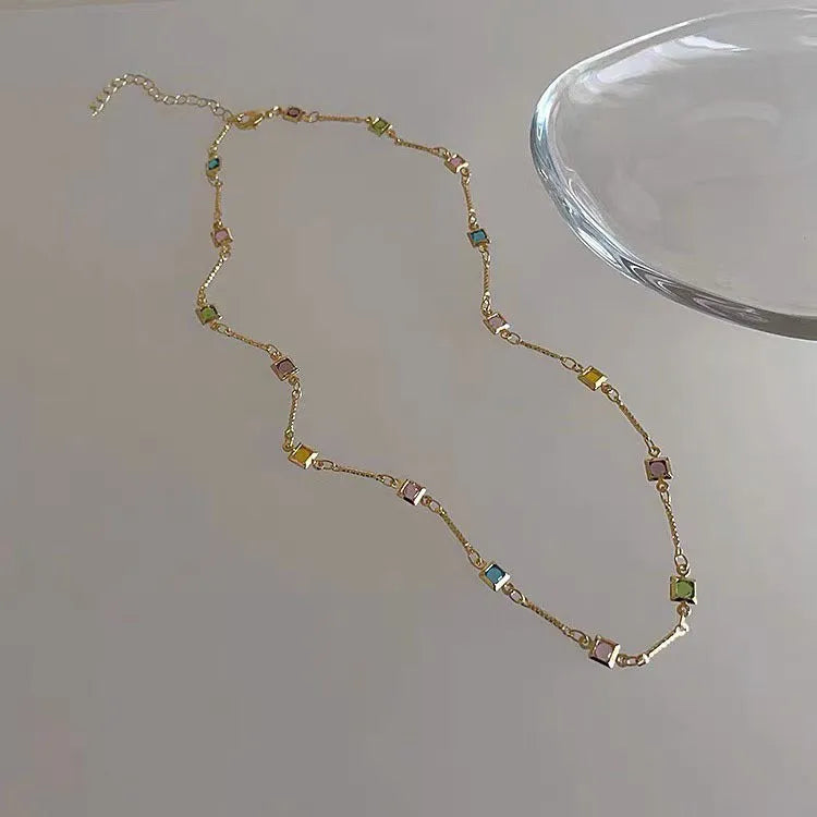 Square colour geometric clavicle chain necklace with artificial crystals in gold or white K tone finish.
