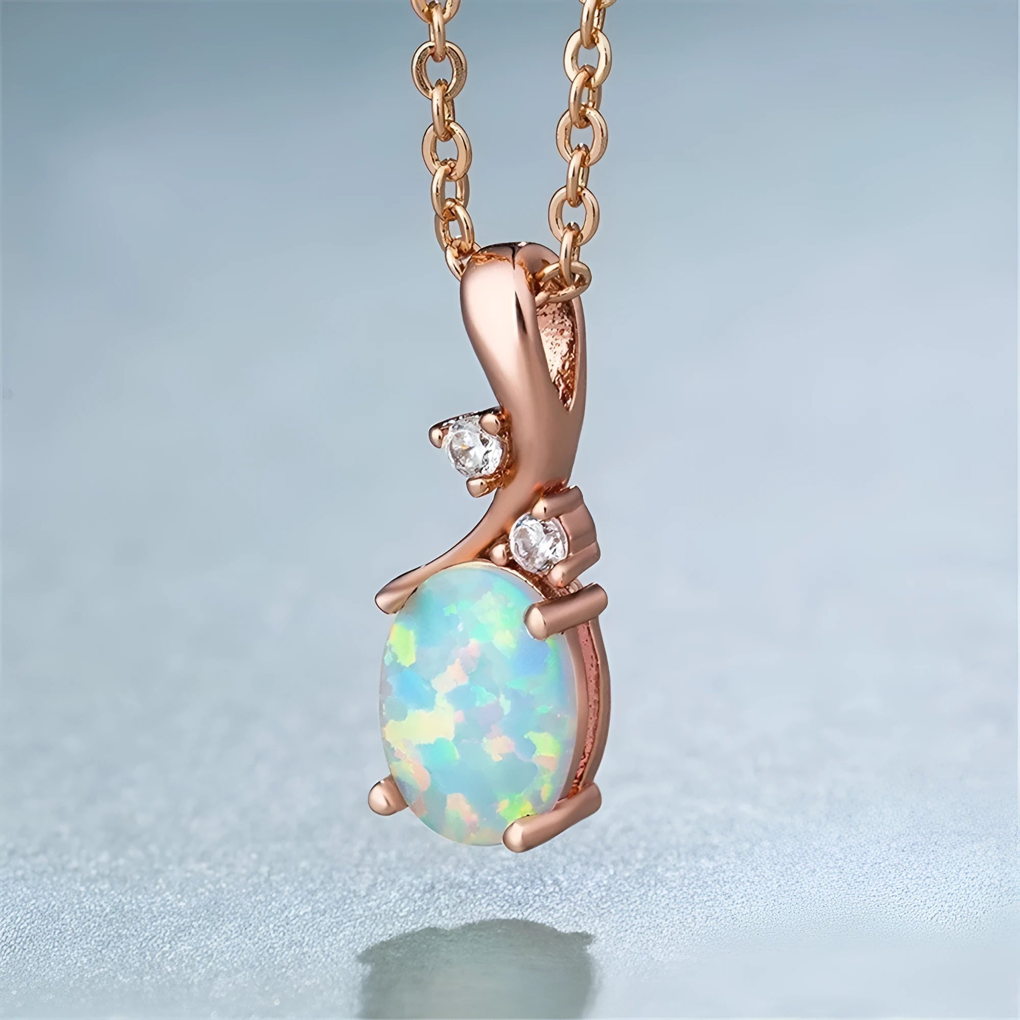 Water drop shaped opal pendant necklace on an adjustable chain in rose gold or white colour.