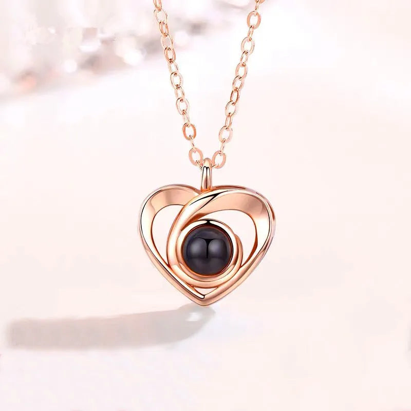S925 silver heart shaped photo projection pendant necklace with silver finish on white background