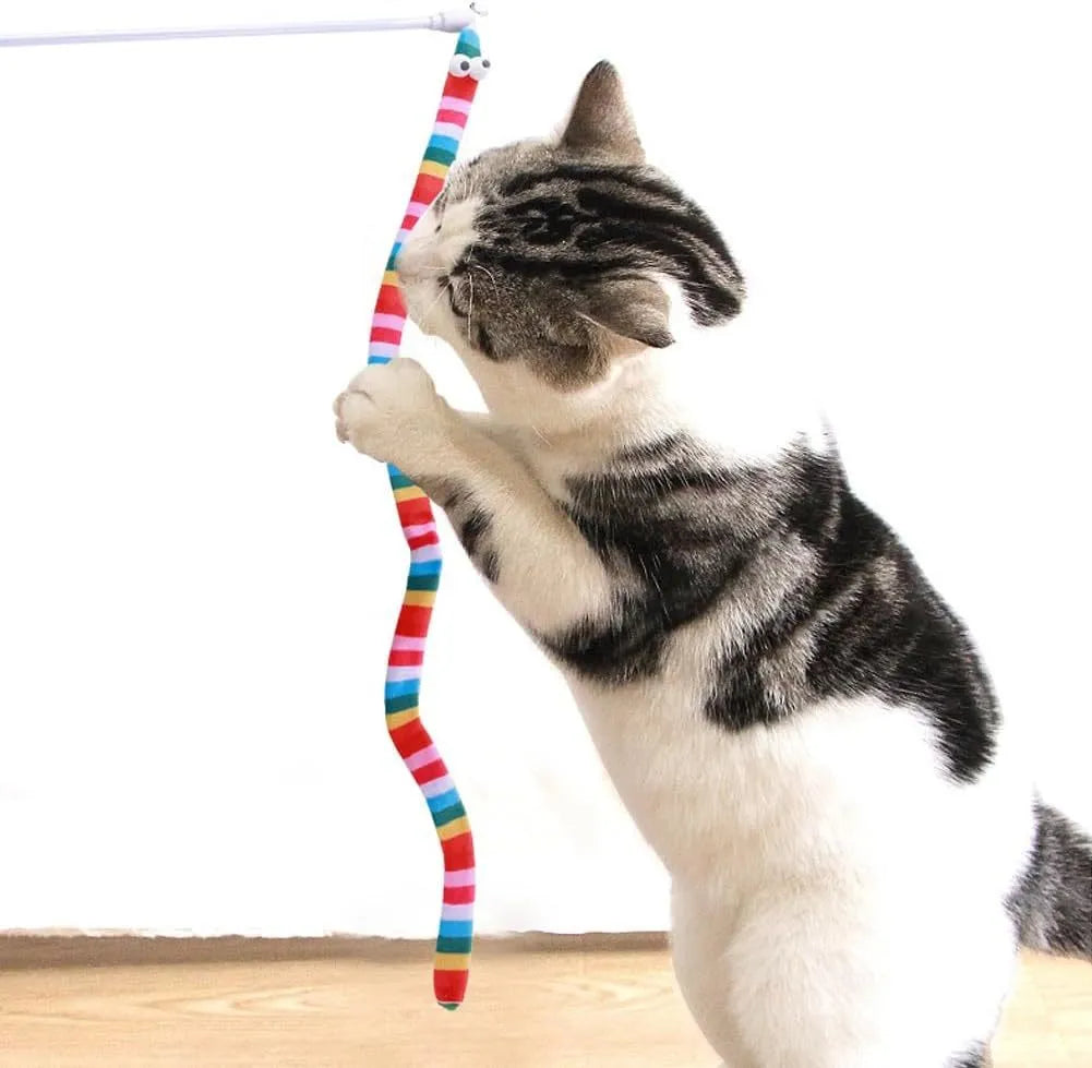 Cat wand toy with a polycarbonate pole and a long colourful plush strip with a bell, held in a person's hand.