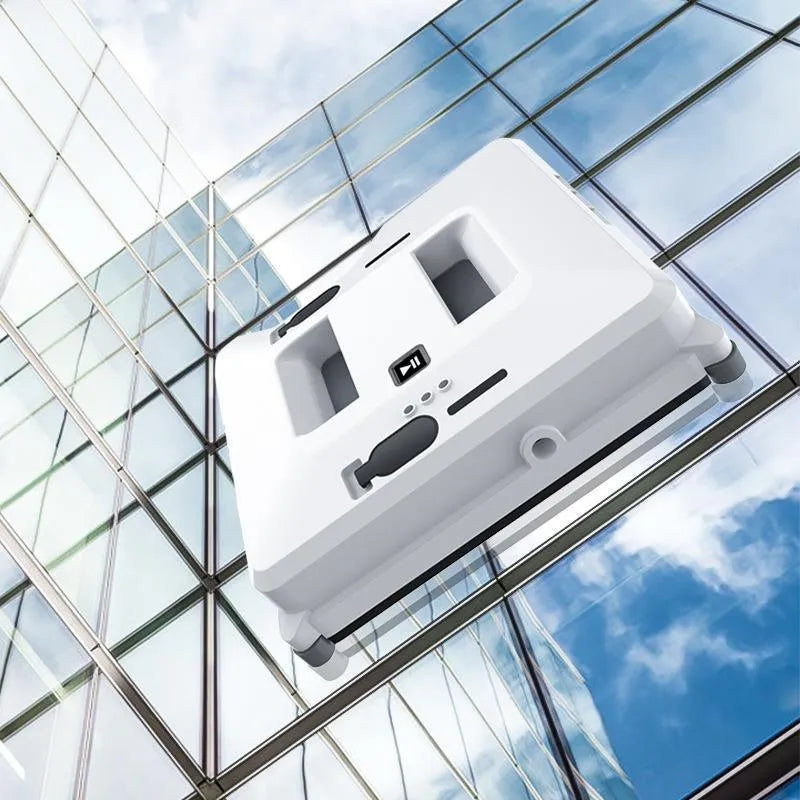 White intelligent small window cleaner robot on smooth indoor glass surface with plastic body