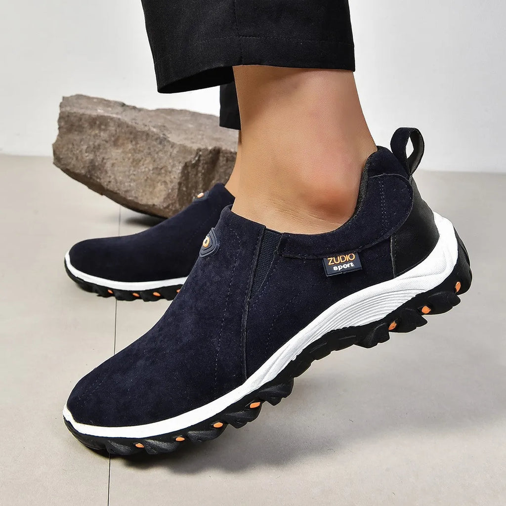 Men's grey round head overshoe cover with rubber sole, shown from the side.