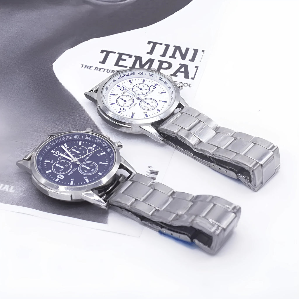 Men's quartz wrist watch set with round alloy dial, black face, and stainless steel buckle on a plain background