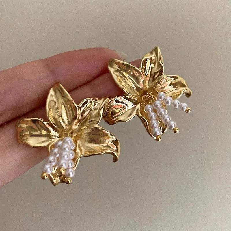 Exaggerated gold H1795 pearl flower earrings with Seiko crystal treatment, showing floral design.