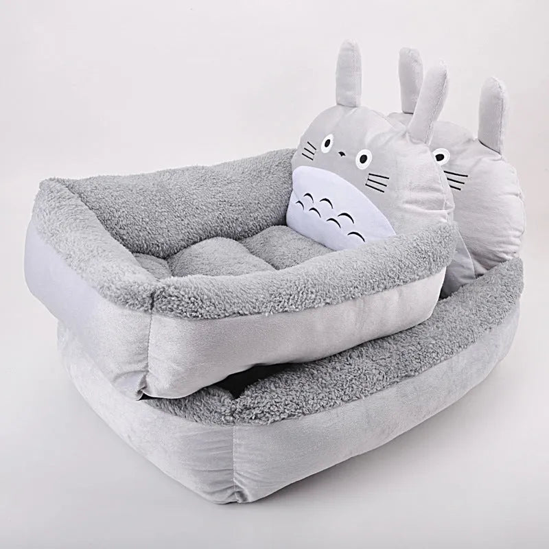 A blue cartoon-style pet sofa bed with raised sides for a small dog, showcasing its washable cover and non-slip base.