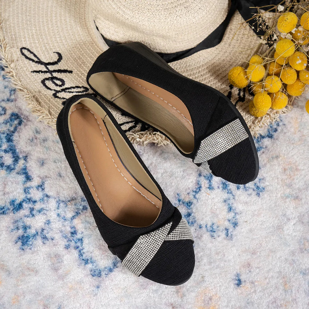 Black women's slip-on casual shoes with rhinestone detail on fabric upper and a short chunky heel.