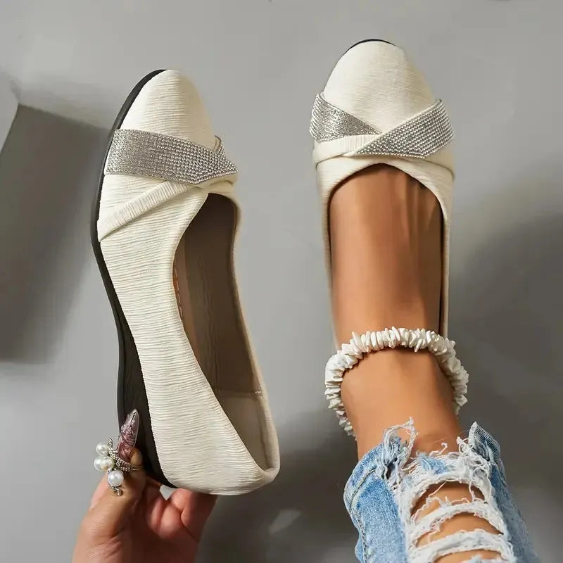 Black women's slip-on casual shoes with rhinestone detail on fabric upper and a short chunky heel.