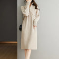 Beige half zip long sleeve midi skirt with a stand collar and straight silhouette