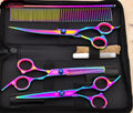 Three pet grooming scissors with purple handles on white background including curved flat and tooth shears