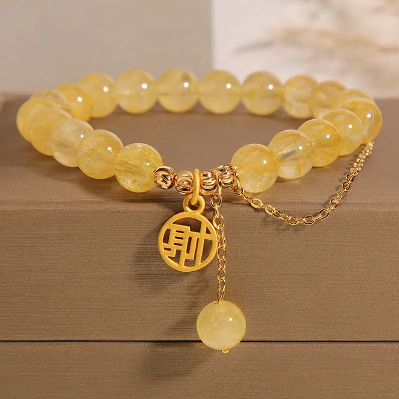 Natural stone citrine bracelet with Chinese character tassel in either Cai or Fu design