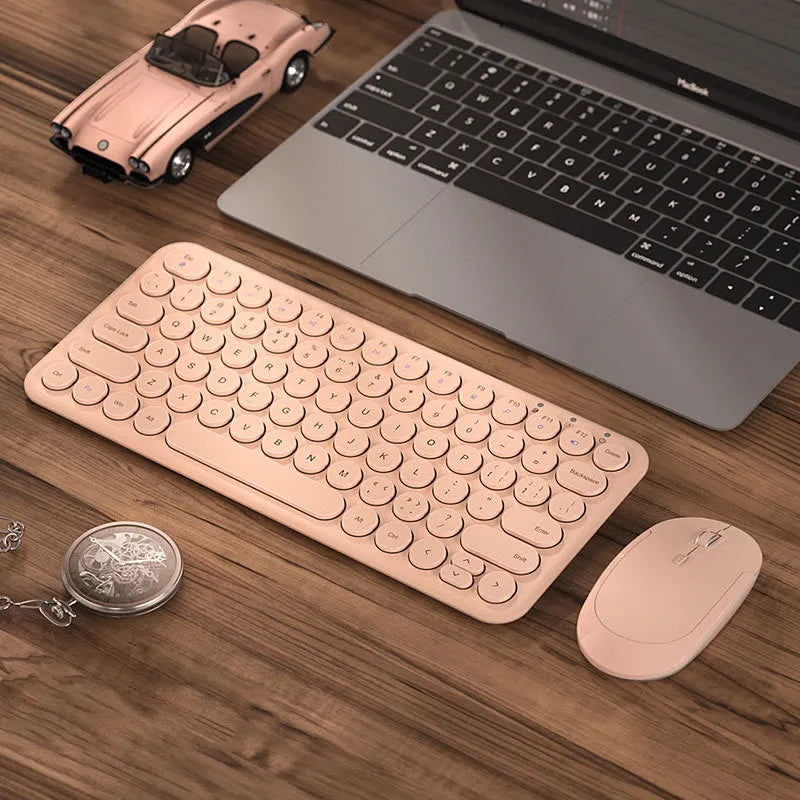 Ultra-thin white wireless keyboard and mouse set with USB receiver on a desk.