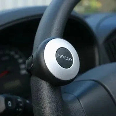 Car steering wheel spinner knob in black with metal fixing ring and screw for one-handed driving assistance