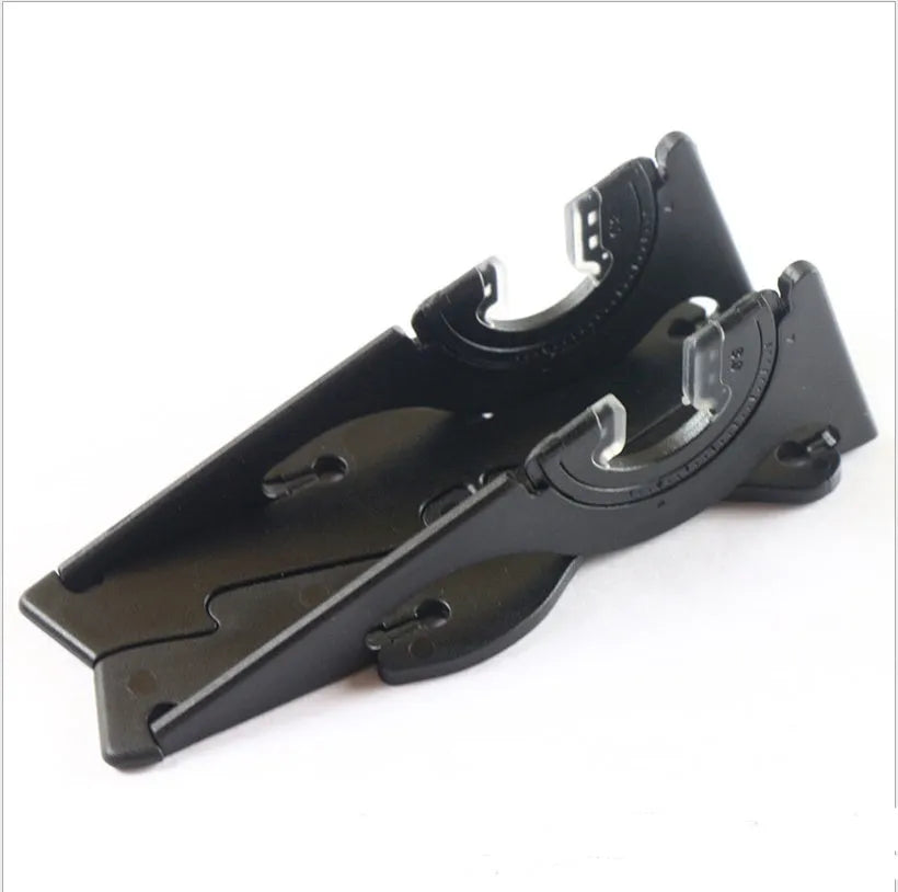 Black plastic card type mobile phone holder on desktop surface